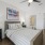 a bedroom with a bed and a fan