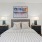 a bedroom with a bed and a fan