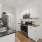 a kitchen with a sink and white cabinets