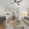 spacious living room with ceiling fan, dining nook and kitchen 